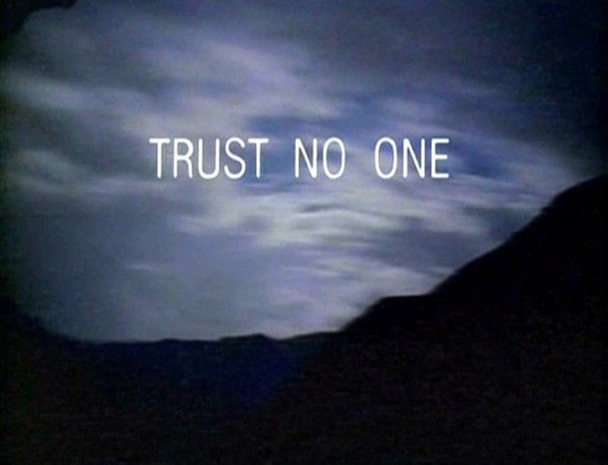 X Files intro screenshot, grainy picture of sky and mountains, text "trust no one" 