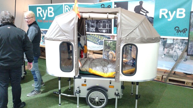 "Ride your Bed" (RyB, campcycle.ch), an oval-ish 50kg folding caravan with a canvas top for use with e-bikes.

A product shown at the fair.