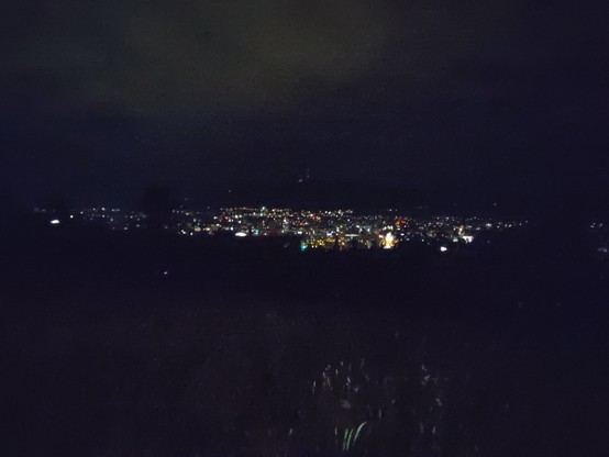 Center of Zurich by night in the distance.

Shot from some ridge above Höngg (an outer quarter of Zurich).