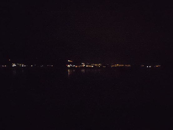 Night view over a lake with city lights on the other lakeside. Take at the Jona delta, looking towards southwest.