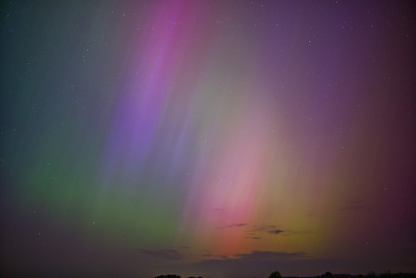 Picture of a night sky, with aurora borealis, green, yellow, red, purple colors visible