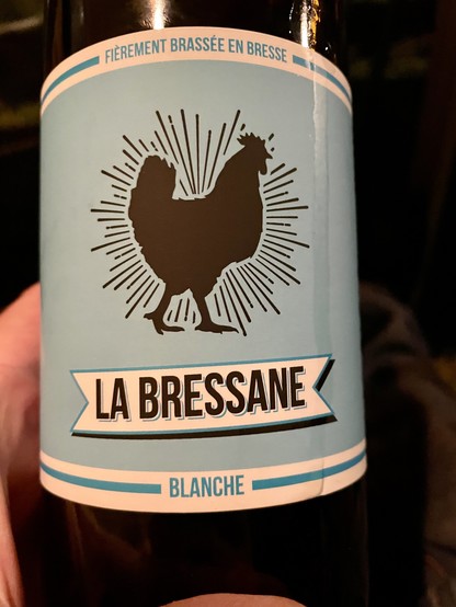 Photo of a label of a beer bottle. It says “La Bressane - Blanche” and shows a rooster.
