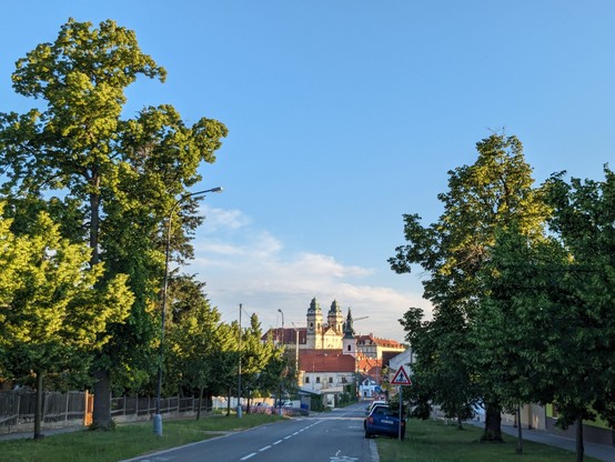 Straße nach Valtice, in Hintergrund Stadt zu sehen, die überragt ist von Kirche und Schloss