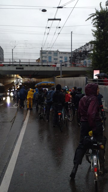 The crowd on its first time through the Langstrasse underbridge beneath the railway tracks to main station. The street is clearly wet.