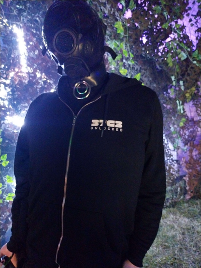 A person wearing a mask, black hoodie in front of hexagonal LED strips
