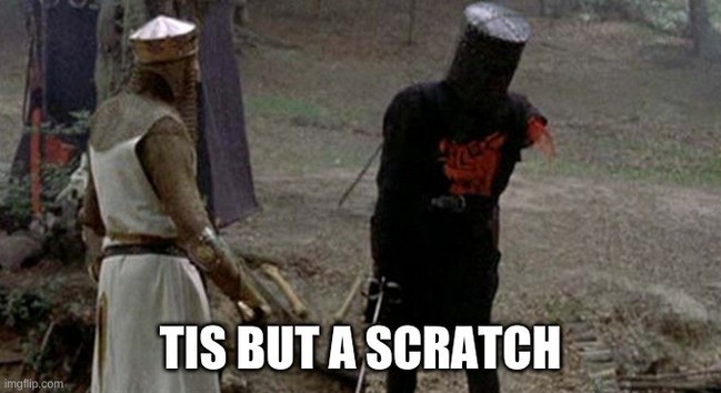 A screenshot from Monty Python and the Holy Grait. It depicts the fight scene of King Arthur and the Black Knight. The knight is missing his left arm and the caption reads 