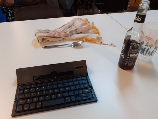 A towel for kitchen duty, a spoon for tasting, my bluetooth keyboard & a Fritz Cola.